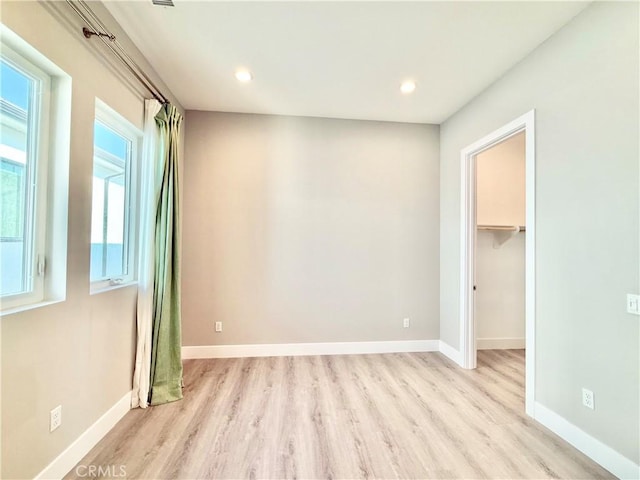 unfurnished bedroom with recessed lighting, baseboards, and wood finished floors