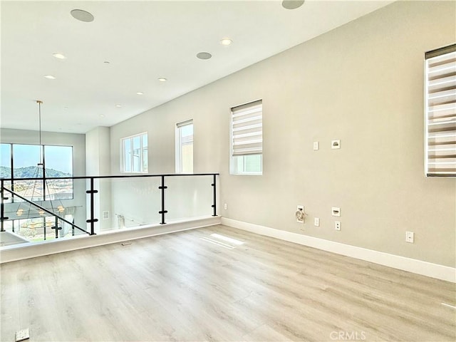 spare room with recessed lighting, baseboards, and light wood-style flooring