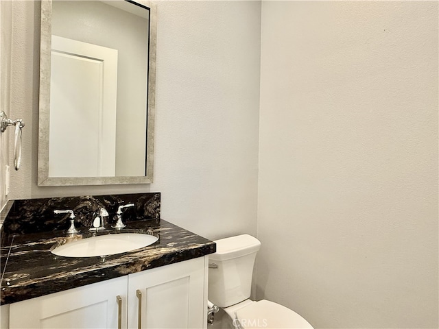 bathroom with toilet and vanity