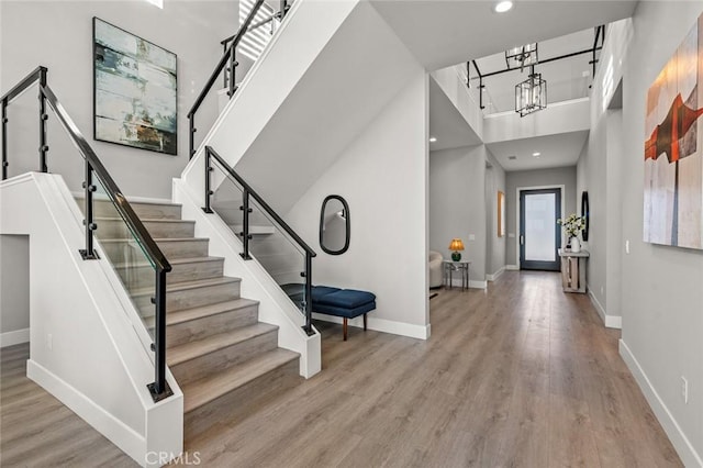 20526 W Overlook Ct, Porter Ranch, CA 91326 - entrance foyer with stairs, wood finished floors, baseboards, a chandelier, and a towering ceiling