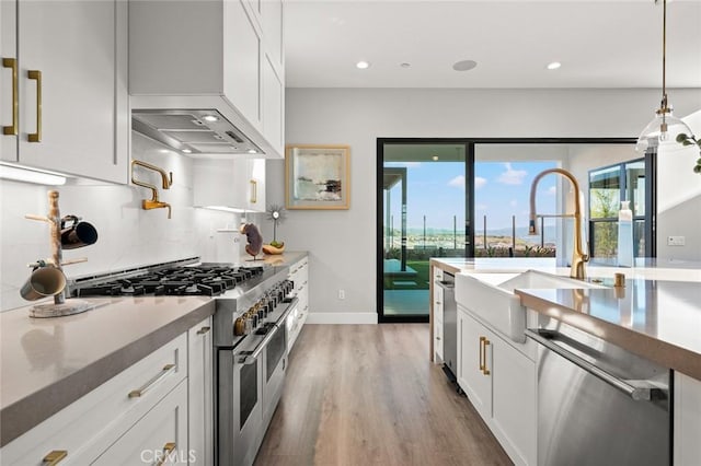 20526 W Overlook Ct, Porter Ranch, CA 91326 - kitchen featuring appliances with stainless steel finishes, a sink, light wood-style flooring, white cabinetry, and recessed lighting