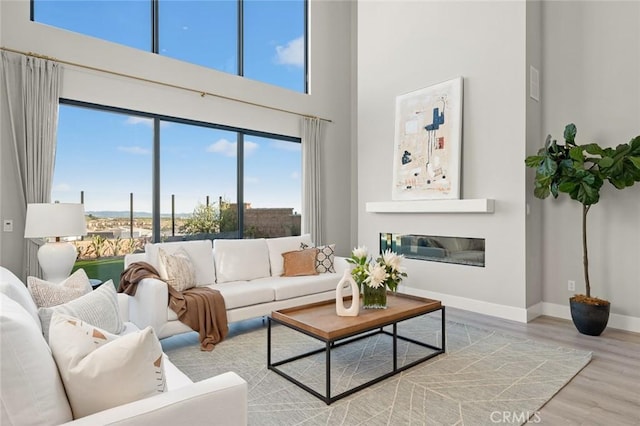 20526 W Overlook Ct, Porter Ranch, CA 91326 - living area featuring a high ceiling, wood finished floors, baseboards, and plenty of natural light