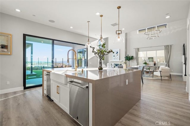 20526 W Overlook Ct, Porter Ranch, CA 91326 - kitchen with a sink, wood finished floors, white cabinets, a center island with sink, and open floor plan