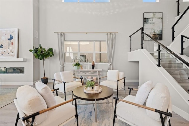 20526 W Overlook Ct, Porter Ranch, CA 91326 - living room featuring a high ceiling, stairs, baseboards, and wood finished floors