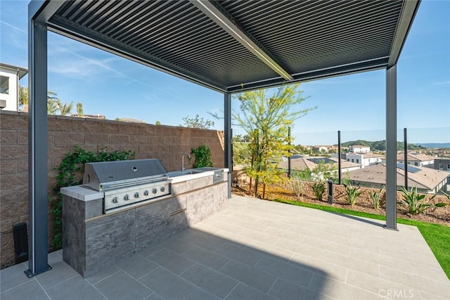 20526 W Overlook Ct, Porter Ranch, CA 91326 - view of patio with grilling area, exterior kitchen, fence, and a sink