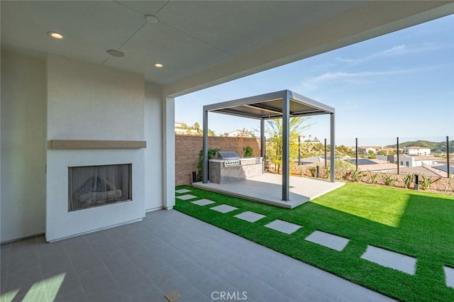 20526 W Overlook Ct, Porter Ranch, CA 91326 - view of patio featuring an outdoor fireplace, an outdoor kitchen, and a residential view