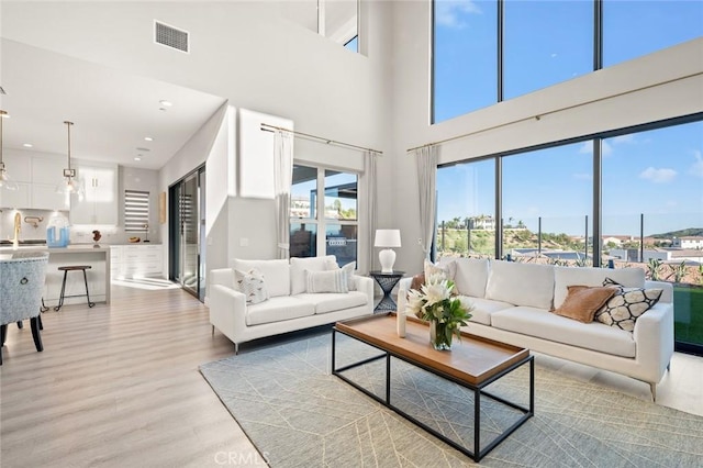 20526 W Overlook Ct, Porter Ranch, CA 91326 - living room featuring light wood-style floors, a high ceiling, and recessed lighting