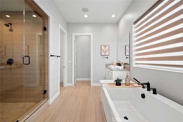 20526 W Overlook Ct, Porter Ranch, CA 91326 - bathroom with a shower stall, a freestanding tub, vanity, recessed lighting, and baseboards