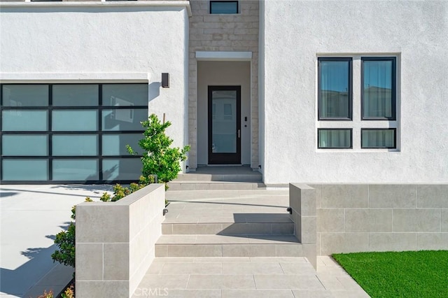 20526 W Overlook Ct, Porter Ranch, CA 91326 - property entrance with stucco siding, a garage, and driveway