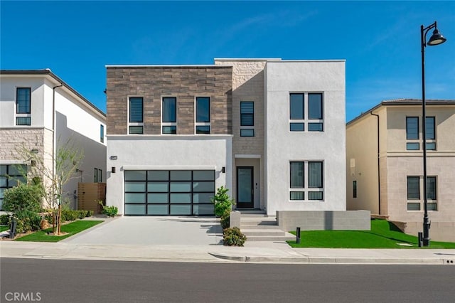 20526 W Overlook Ct, Porter Ranch, CA 91326 - modern home with concrete driveway, stucco siding, an attached garage, and stone siding