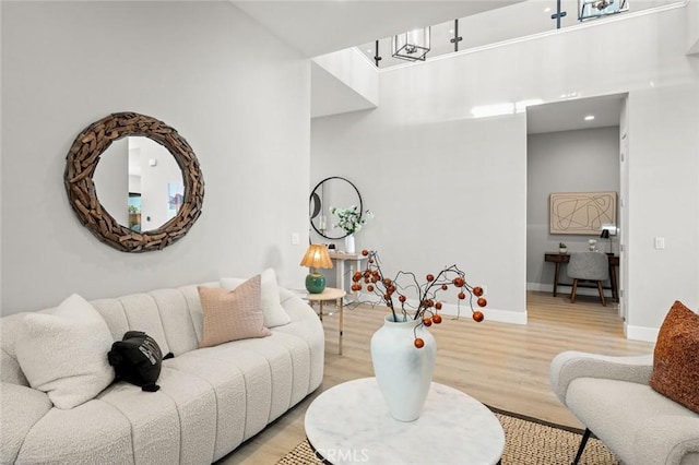 20526 W Overlook Ct, Porter Ranch, CA 91326 - living area featuring light wood-type flooring, baseboards, and a high ceiling