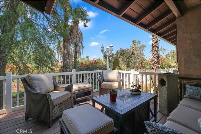 wooden terrace with an outdoor hangout area