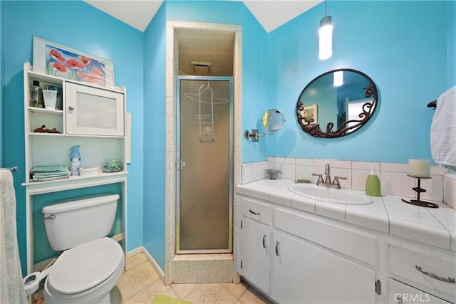 bathroom with vanity, tile patterned flooring, a shower stall, and toilet