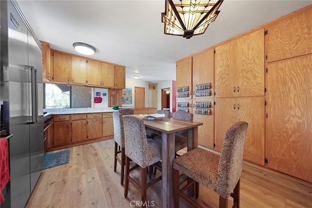 dining room with a chandelier and light wood-type flooring