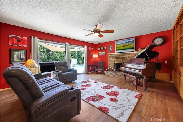 120 Franklin Ave, Redlands, CA 92373 - living room featuring a ceiling fan, a textured ceiling, wood finished floors, and a fireplace