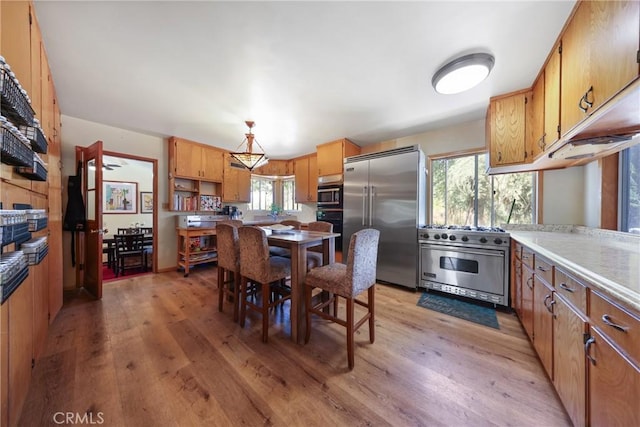 120 Franklin Ave, Redlands, CA 92373 - kitchen with premium appliances, light wood-type flooring, plenty of natural light, and light countertops