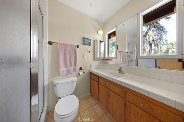 bathroom featuring baseboards, a shower stall, toilet, and a wealth of natural light