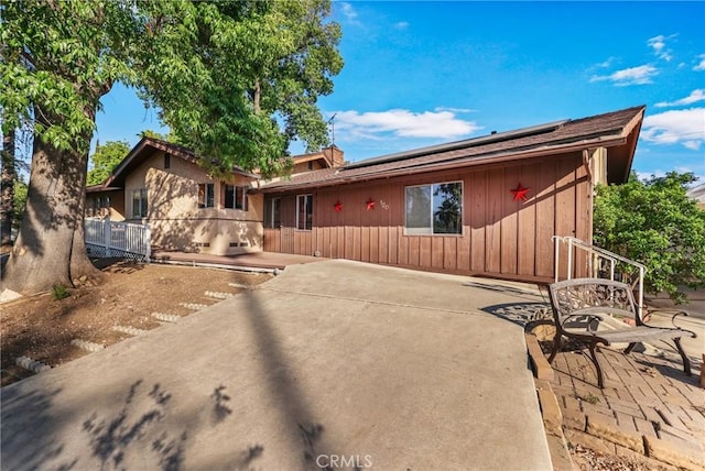120 Franklin Ave, Redlands, CA 92373 - single story home featuring roof mounted solar panels, a patio, and board and batten siding