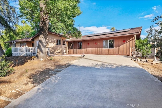 120 Franklin Ave, Redlands, CA 92373 - ranch-style home with roof mounted solar panels, board and batten siding, and stucco siding