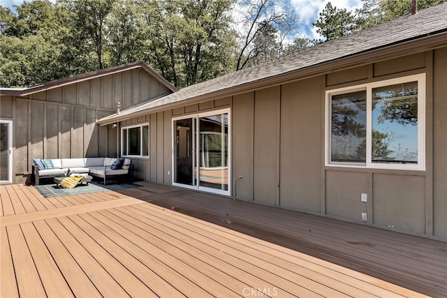 wooden deck with an outdoor living space