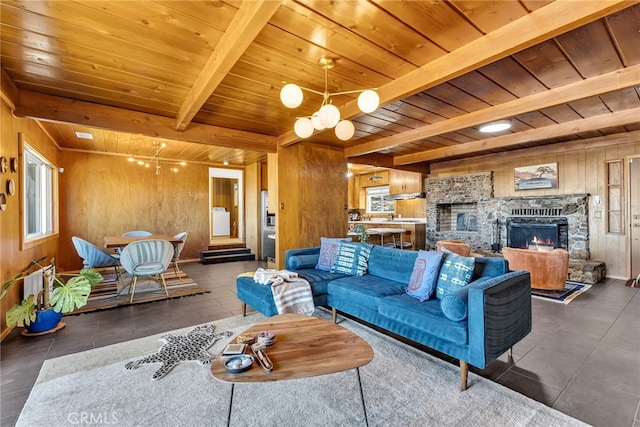 living room with wood ceiling, a fireplace, tile patterned floors, beamed ceiling, and wooden walls