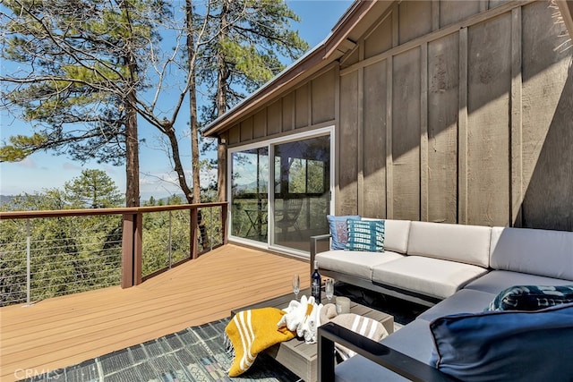 wooden terrace featuring an outdoor hangout area