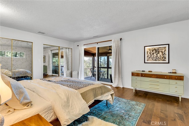 bedroom with visible vents, a textured ceiling, access to outside, and dark wood-style floors