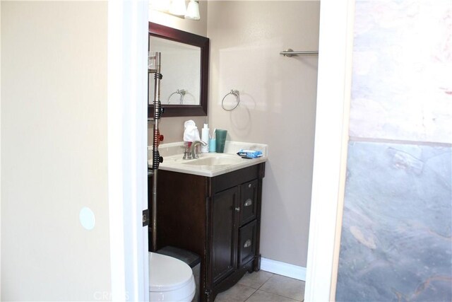 bathroom with vanity, tile patterned flooring, and toilet