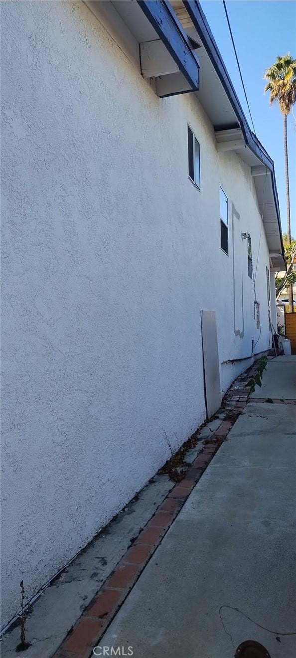 view of side of property with stucco siding