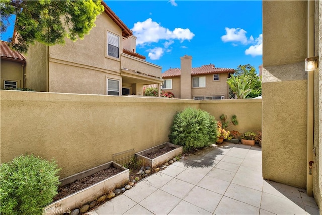 view of patio / terrace featuring fence and a vegetable garden