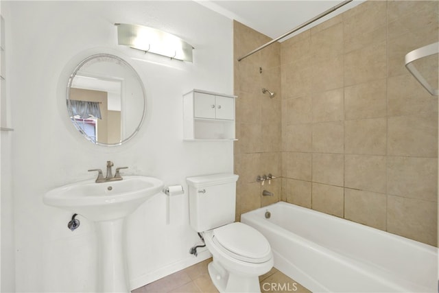 full bath with shower / tub combination, a sink, tile patterned flooring, toilet, and baseboards