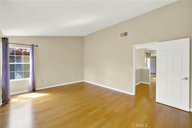spare room with baseboards, visible vents, a wealth of natural light, and light wood-type flooring