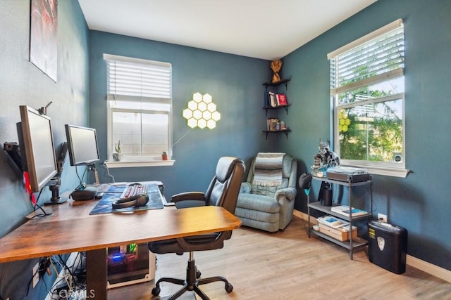 office with baseboards, wood finished floors, and a wealth of natural light