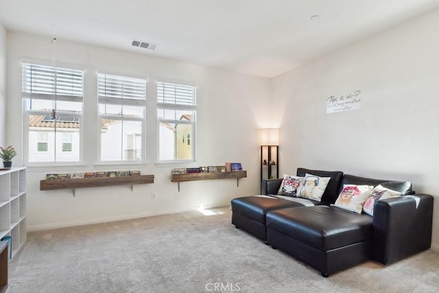 carpeted living area with baseboards and visible vents