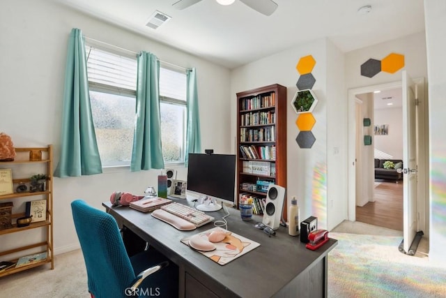 office space with visible vents and ceiling fan