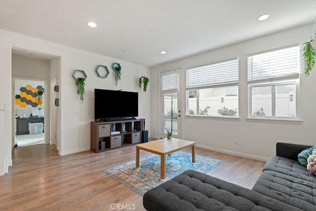 living area with recessed lighting, baseboards, and light wood-style floors
