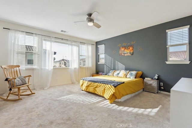 bedroom featuring visible vents, carpet floors, and multiple windows