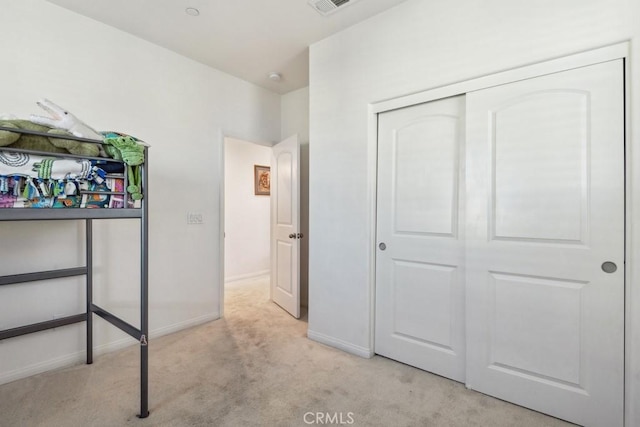 unfurnished bedroom with carpet floors, baseboards, and a closet