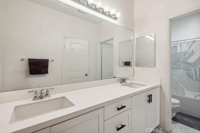 bathroom featuring a sink, toilet, double vanity, and visible vents