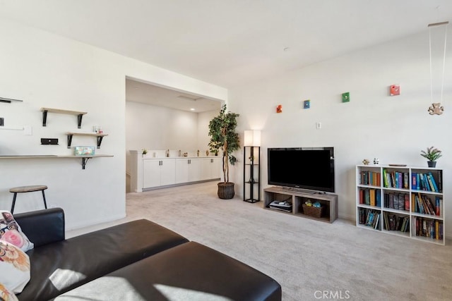 carpeted living room with baseboards