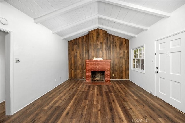 unfurnished living room with wood ceiling, lofted ceiling with beams, a brick fireplace, and wood finished floors