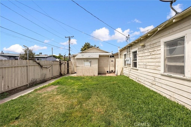 view of yard featuring fence and an outdoor structure