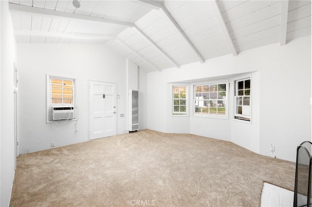 unfurnished living room with carpet flooring, a heating unit, lofted ceiling with beams, and cooling unit