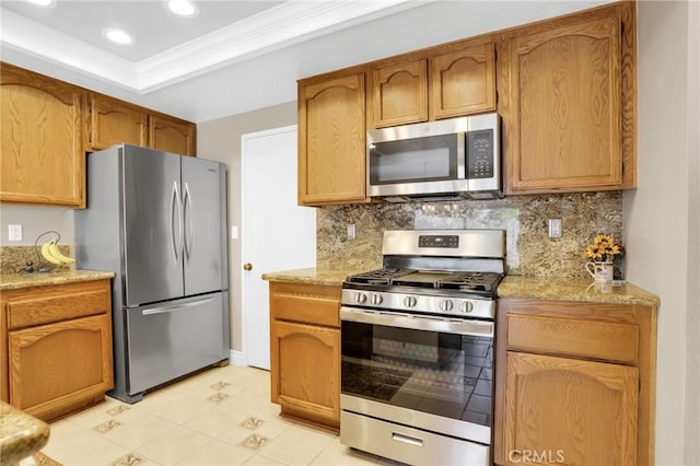 kitchen with crown molding, tasteful backsplash, light countertops, light tile patterned floors, and stainless steel appliances