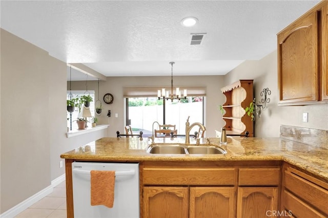 kitchen with a peninsula, light tile patterned flooring, white dishwasher, a textured ceiling, and a sink