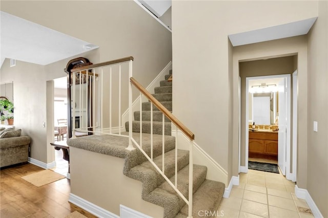 stairway featuring baseboards and wood finished floors