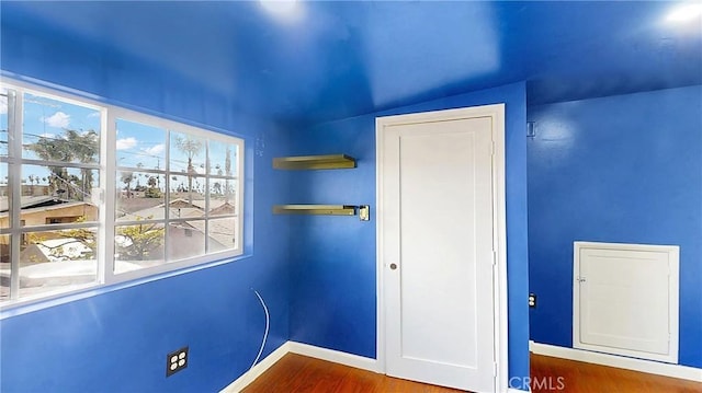 unfurnished bedroom featuring baseboards and wood finished floors