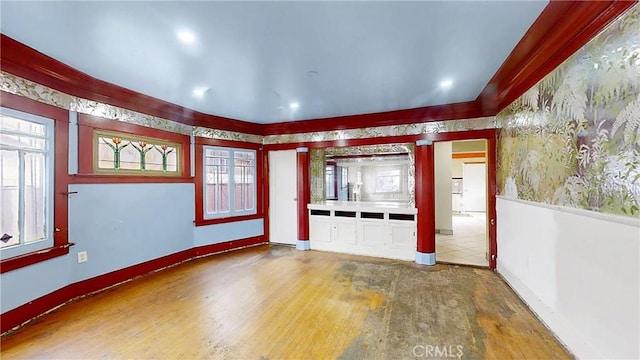 unfurnished room featuring baseboards and wood finished floors