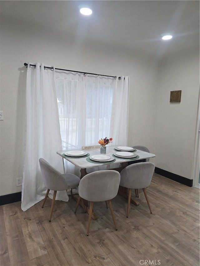dining room with baseboards, recessed lighting, and wood finished floors