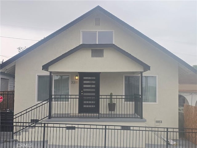 3311 E 4th St, Los Angeles, CA 90063 - bungalow-style home with stucco siding and fence